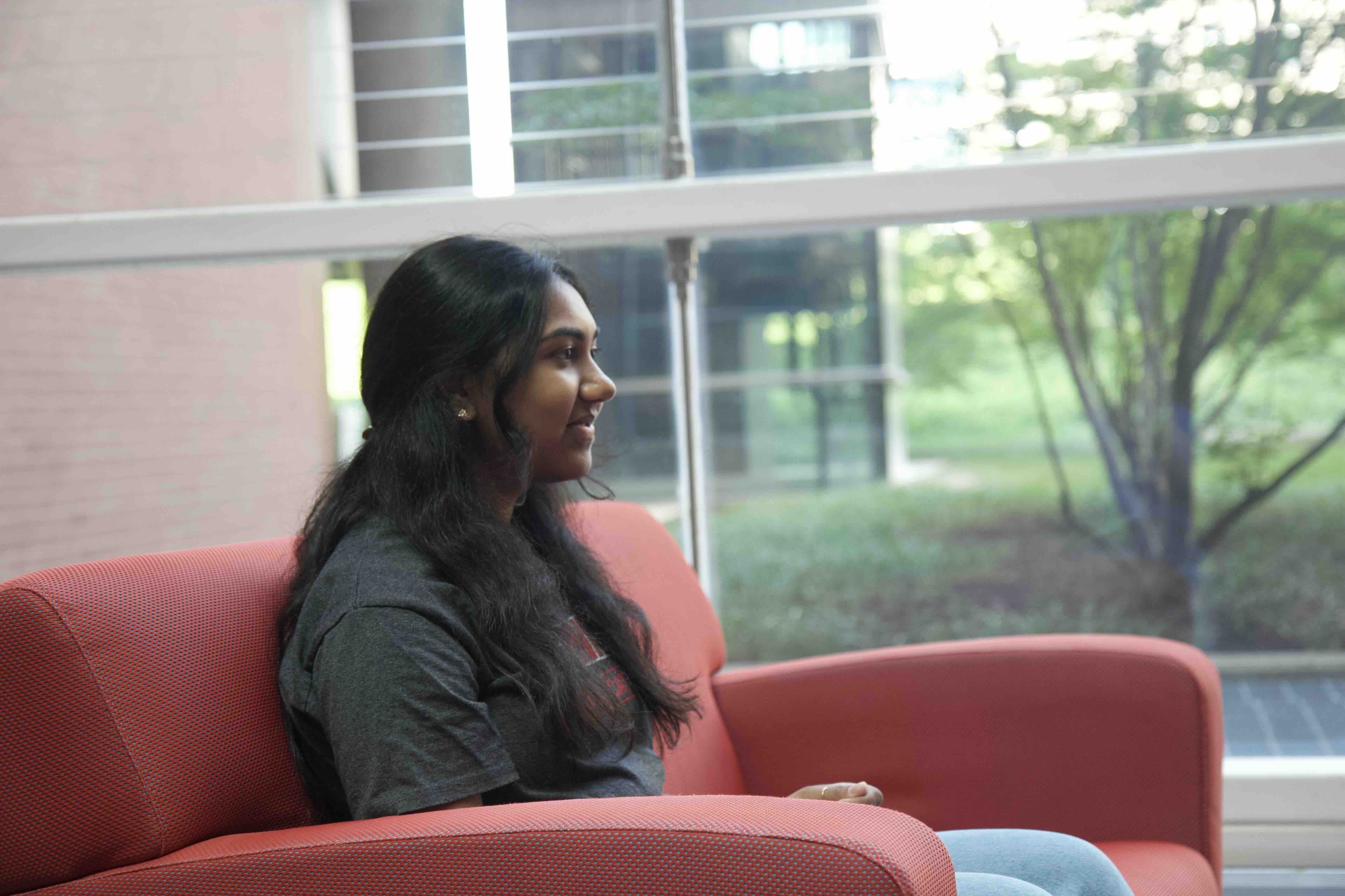 Kaaviya is sitting in a chair