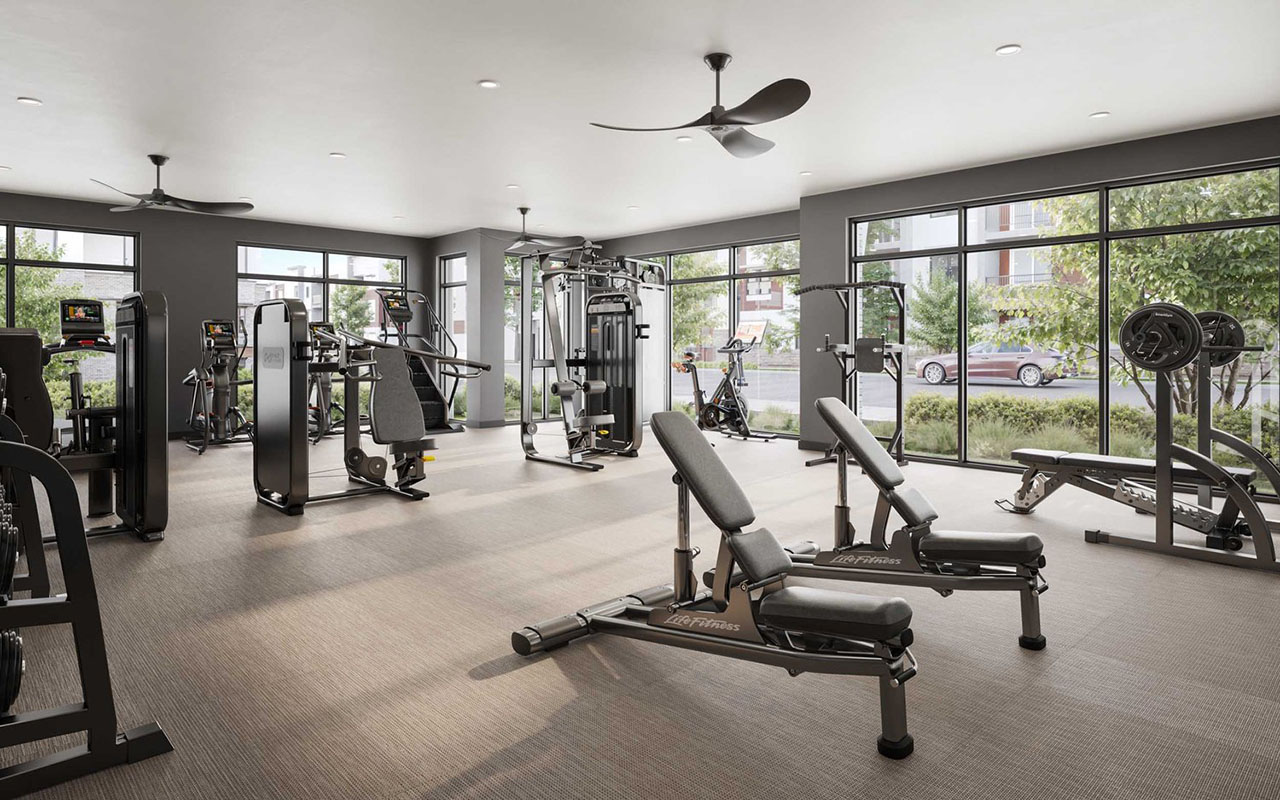 Fitness center with equipment and many windows looking outdoors