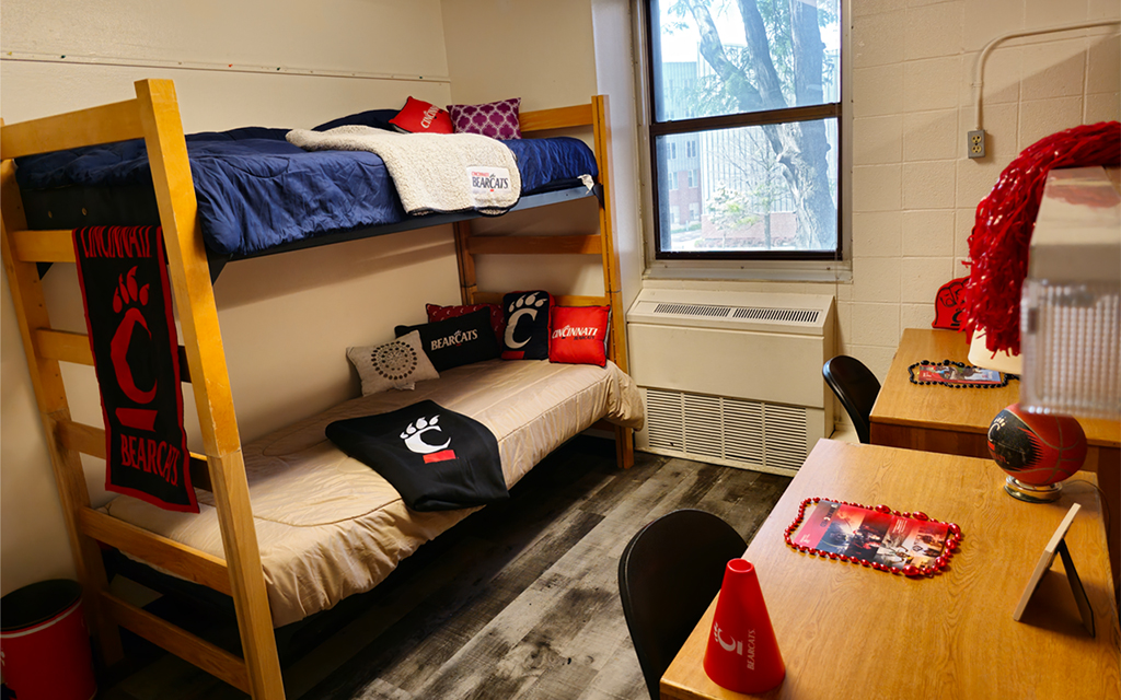 sample of a traditional room showing a bunked bed window and desks. 