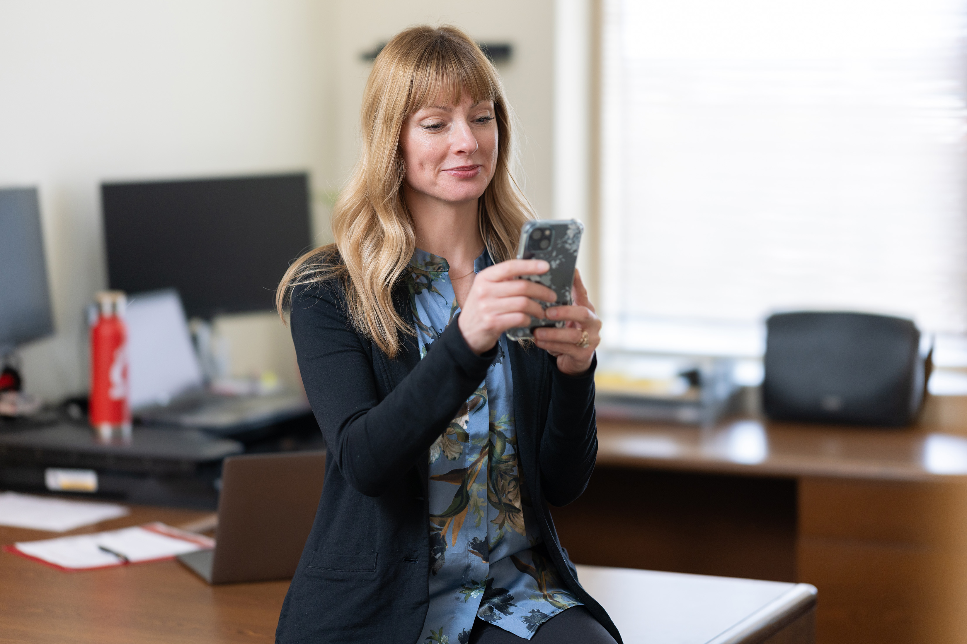woman typing on phone