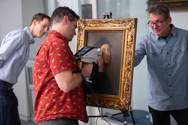 UC geologist Daniel Sturmer uses Raman spectroscopy to learn more about a painting titled Crucifixion at the Taft Museum of Art.
