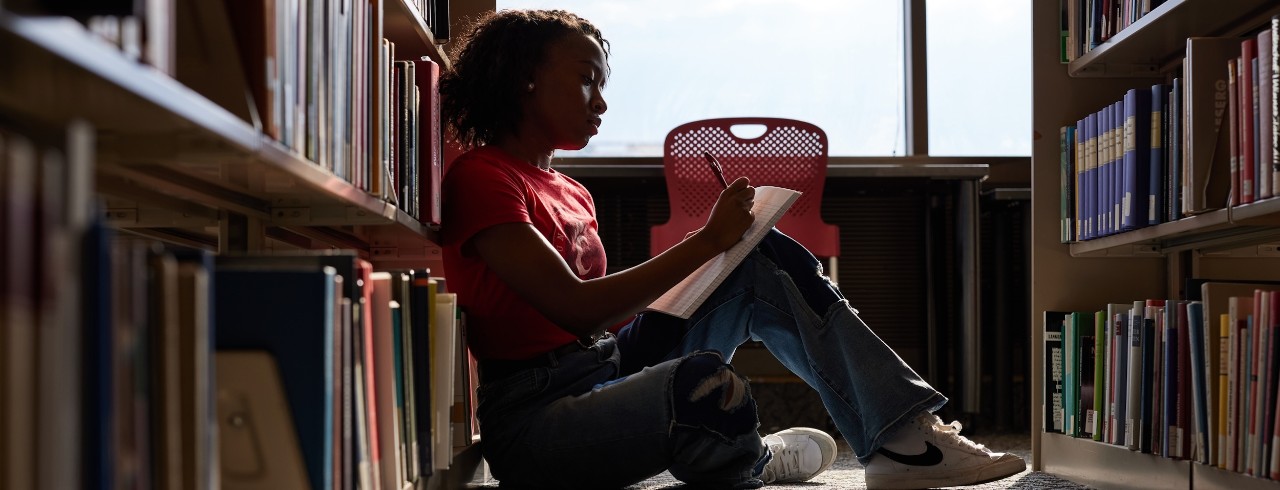 Grad student studying for grad school in library