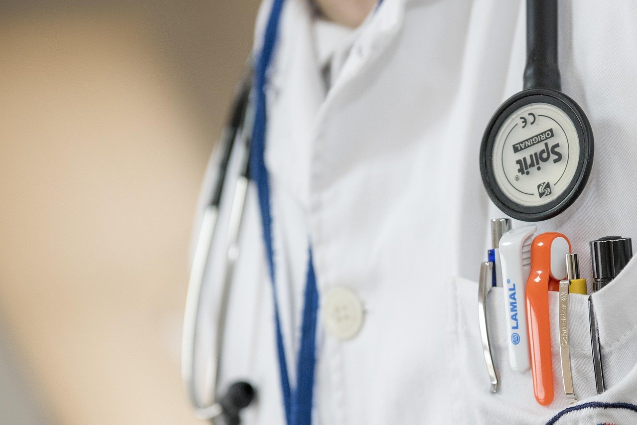 Doctor's white coat. A stethoscope is around the neck and pens are in the pockets. 
