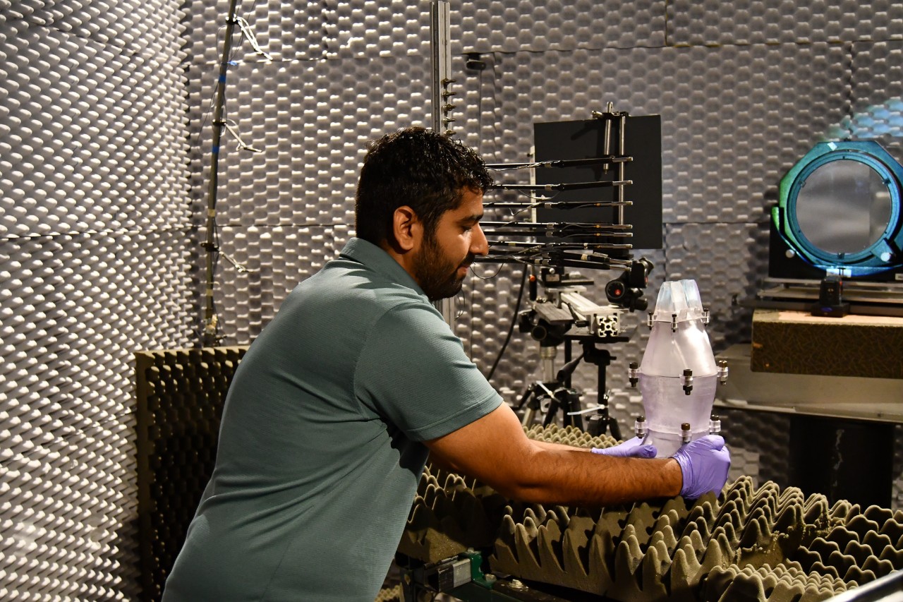 Gautam Kaurab prepares a jet engine for testing in an anechoic chamber.